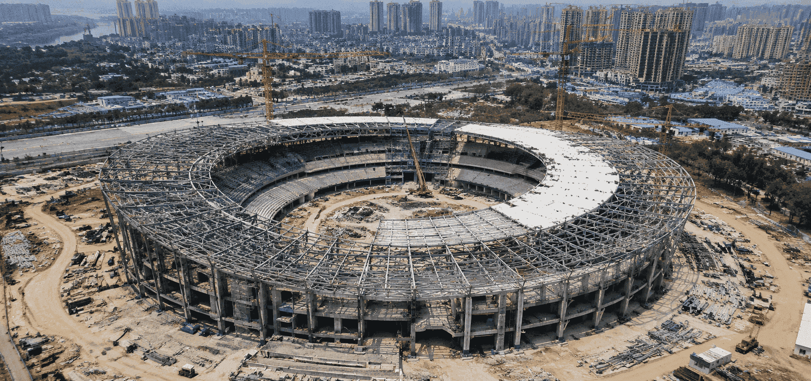 Multi-storey steel structure stadium construction site with large-span roof truss and circular grandstand steel structure
