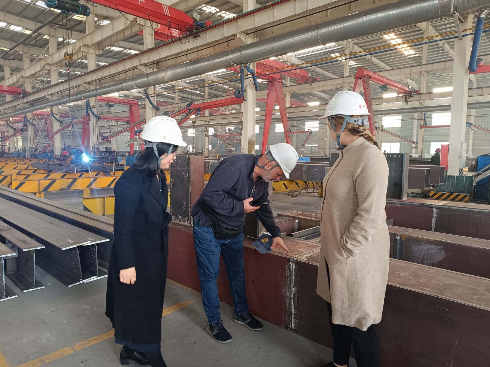 Foreign customers inspect steel structure fabrication details